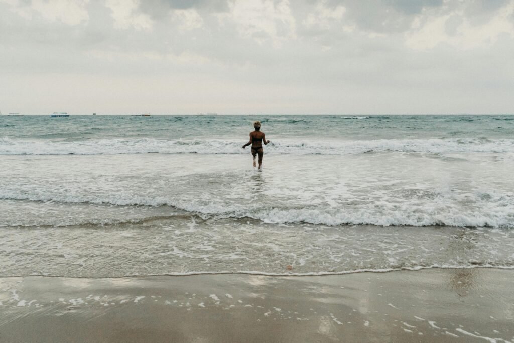 Woman dancing in see beach in there goa tour