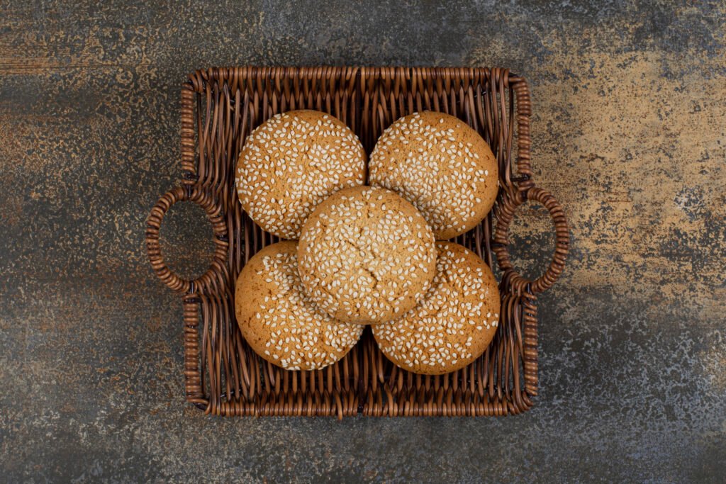 Biscuits with sesame seeds in wooden basket